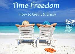 How to get time freedom and enjoy it: a young man and a woman sitting in long chairs out on a beach looking at the ocean.